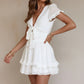 White ruffled V-neck mini dress with tied smocked waist