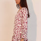 Women’s white and burgundy leopard-print blouse with ruffle cuffs