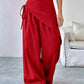 Red Daverri wrap-front wide-leg pants with side tie detail