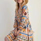 Bohemian floral print long sleeve mini dress in off-white with orange blue green patterns
