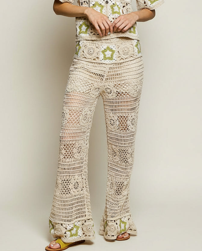 Cream-colored openwork crochet flare pants with green star motifs