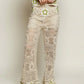 Cream-colored POL openwork crochet flare pants with green star waistband