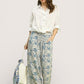 Woman in Umgee Linen Printed Wide Leg Raw Hem Pants with blue leaf pattern