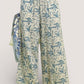 Umgee beige linen wide-leg pants with blue leafy print and raw frayed hems
