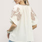 Umgee embroidered sleeve contrast trim top with white fabric and brown patterns