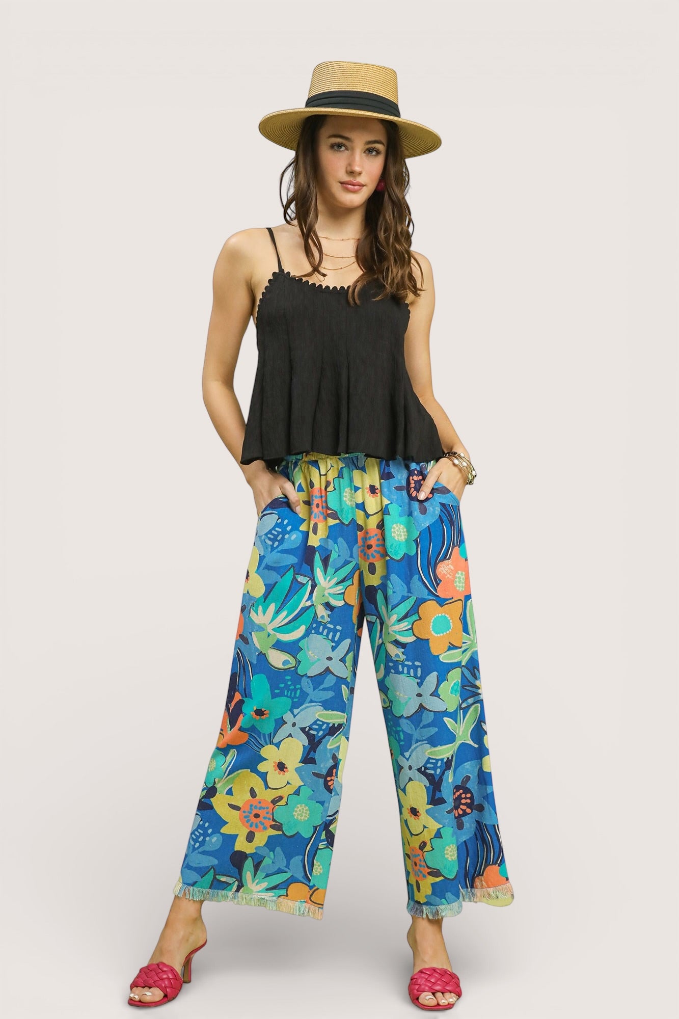 Woman in black peplum top and Umgee floral wide-leg pants