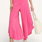 Umgee Flowy asymmetrical hem wide-leg pants in bright pink with silver beaded belt