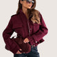 Maroon suede crossbody bag with rounded top handle on Daverri jacket