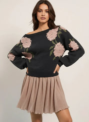 Black floral embroidered boat neck long sleeve sweater with beige pleated skirt