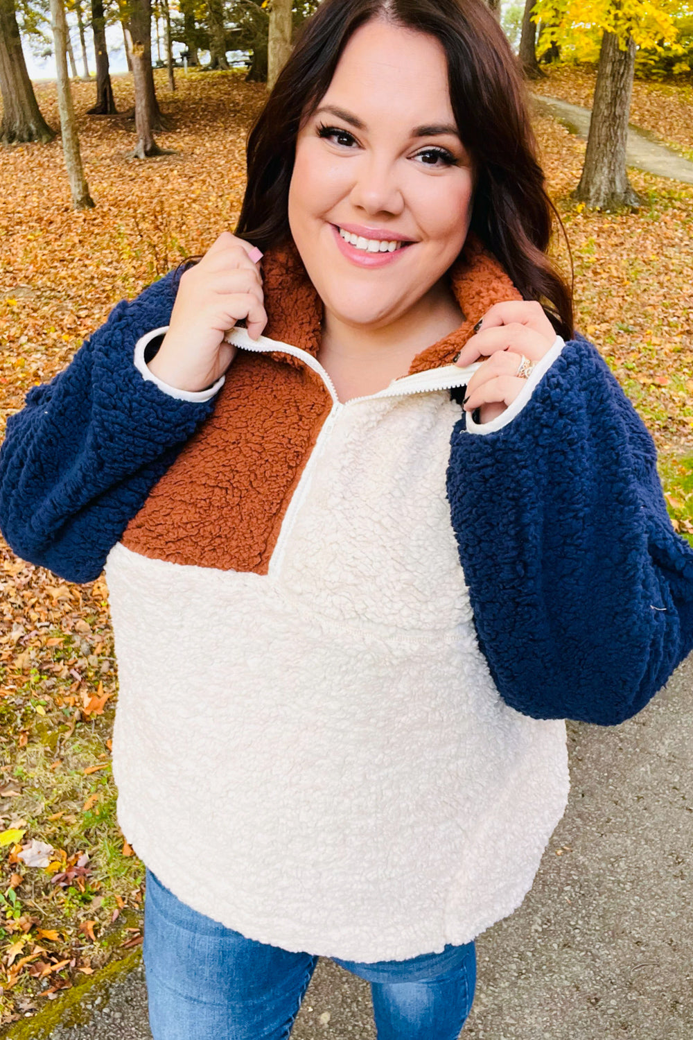 Navy and taupe quarter-zip sherpa pullover with rust collar