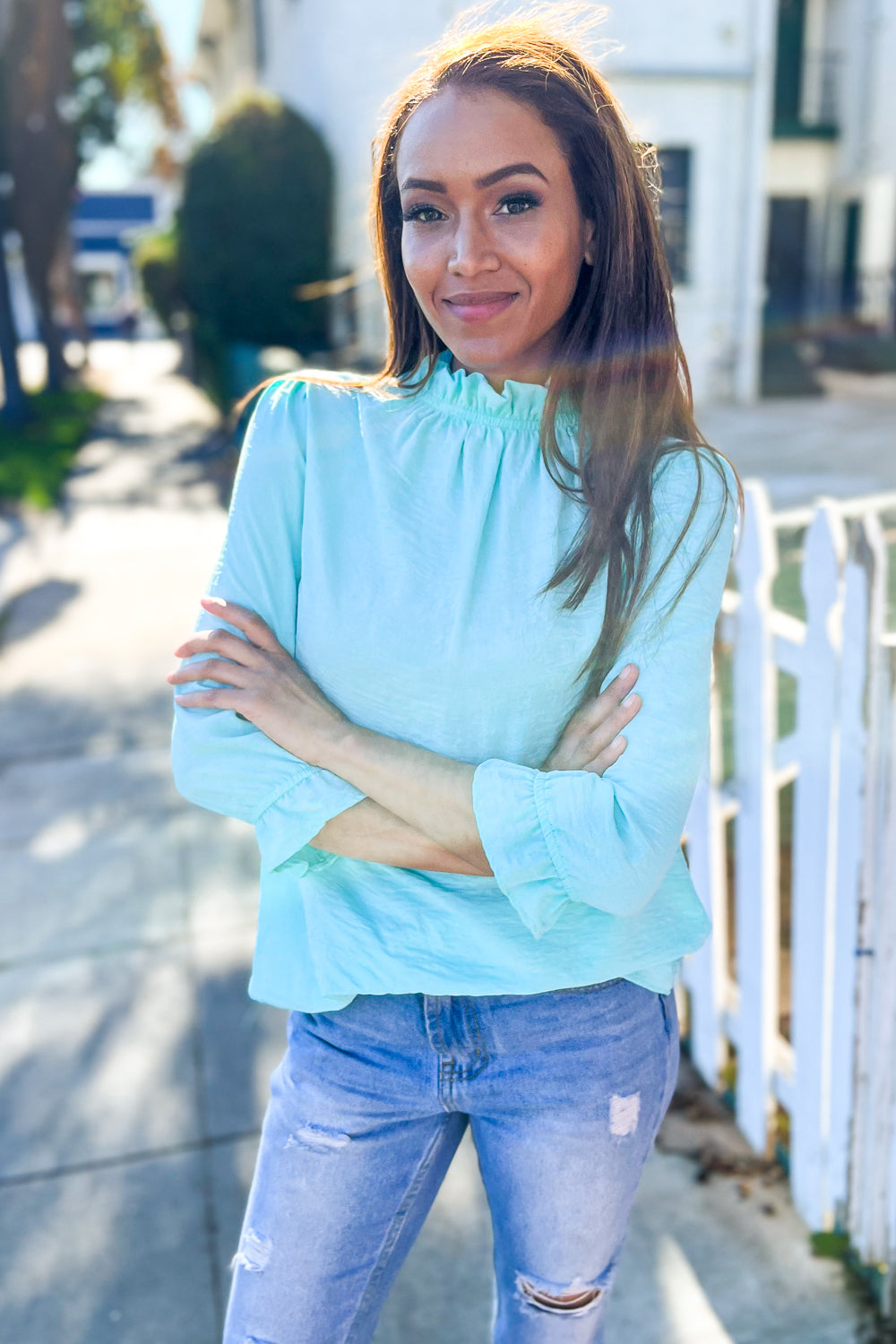 Elegant You mint frill neck ruffle sleeve blouse on woman