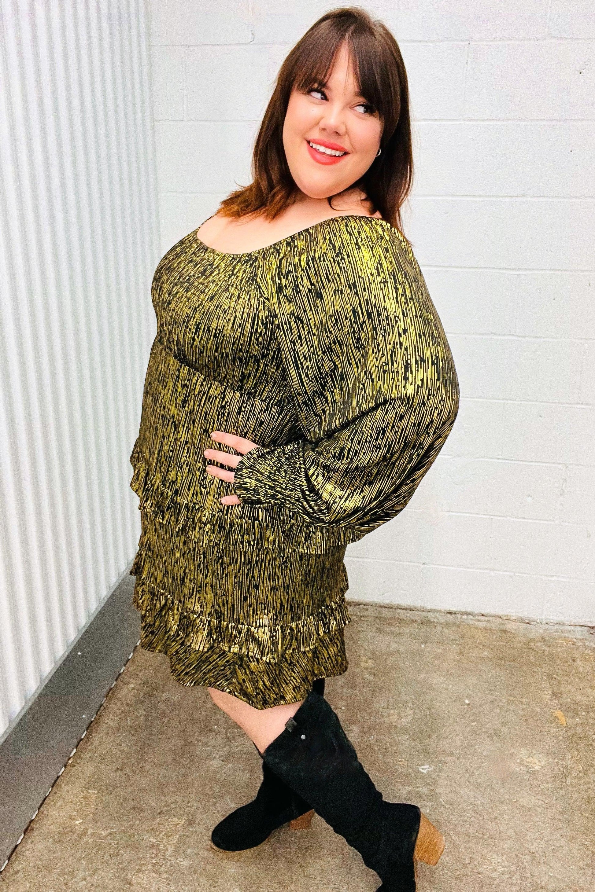 Olive green textured sweater dress with black boots on white wall