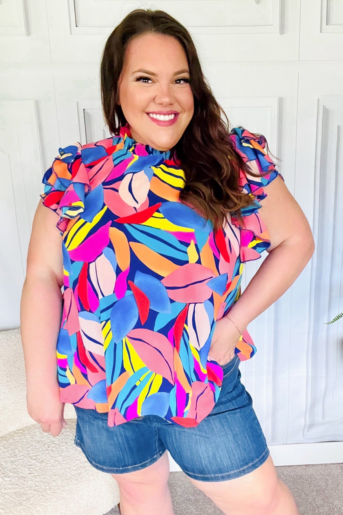 Tropical Vibes blue and pink mock neck flutter sleeve top with vibrant leaf patterns