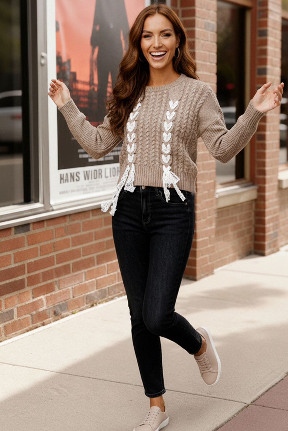 Brown cable knit Sweetheart Stitch Sweater with white heart trim and black jeans