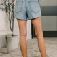 Back view of Paige high waist Wrangler light-wash denim cutoff shorts