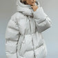 Light gray quilted puffer jacket with hood and pockets