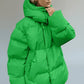 Green pocketed zip-up hooded puffer jacket with oversized sleeves