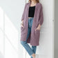 Woman wearing a soft lavender chunky knit open-front cardigan with a waffle texture and large side pockets, paired with jeans.