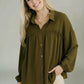 Olive green collared button-down blouse with ruffled neckline and elastic cuffs