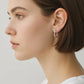 Zircon 925 sterling silver C-hoop earrings with textured surface