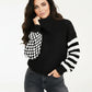 Black turtleneck sweater with checkered and striped sleeves