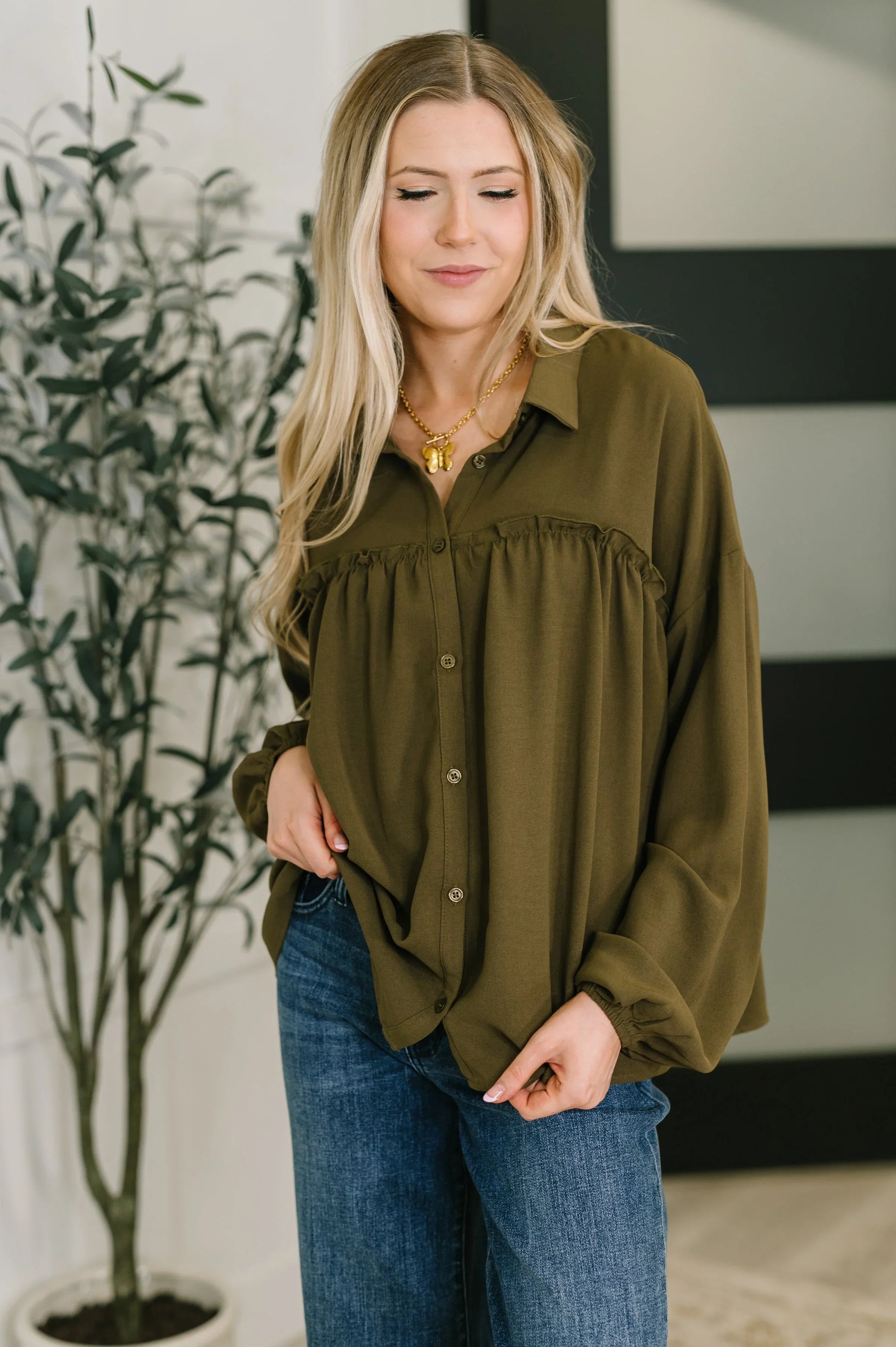 Olive green Shes Got A Way blouse with ruffled hem and button-down front