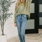 Olive green Shock Value V-neck sweater with white lightning bolt embroidery