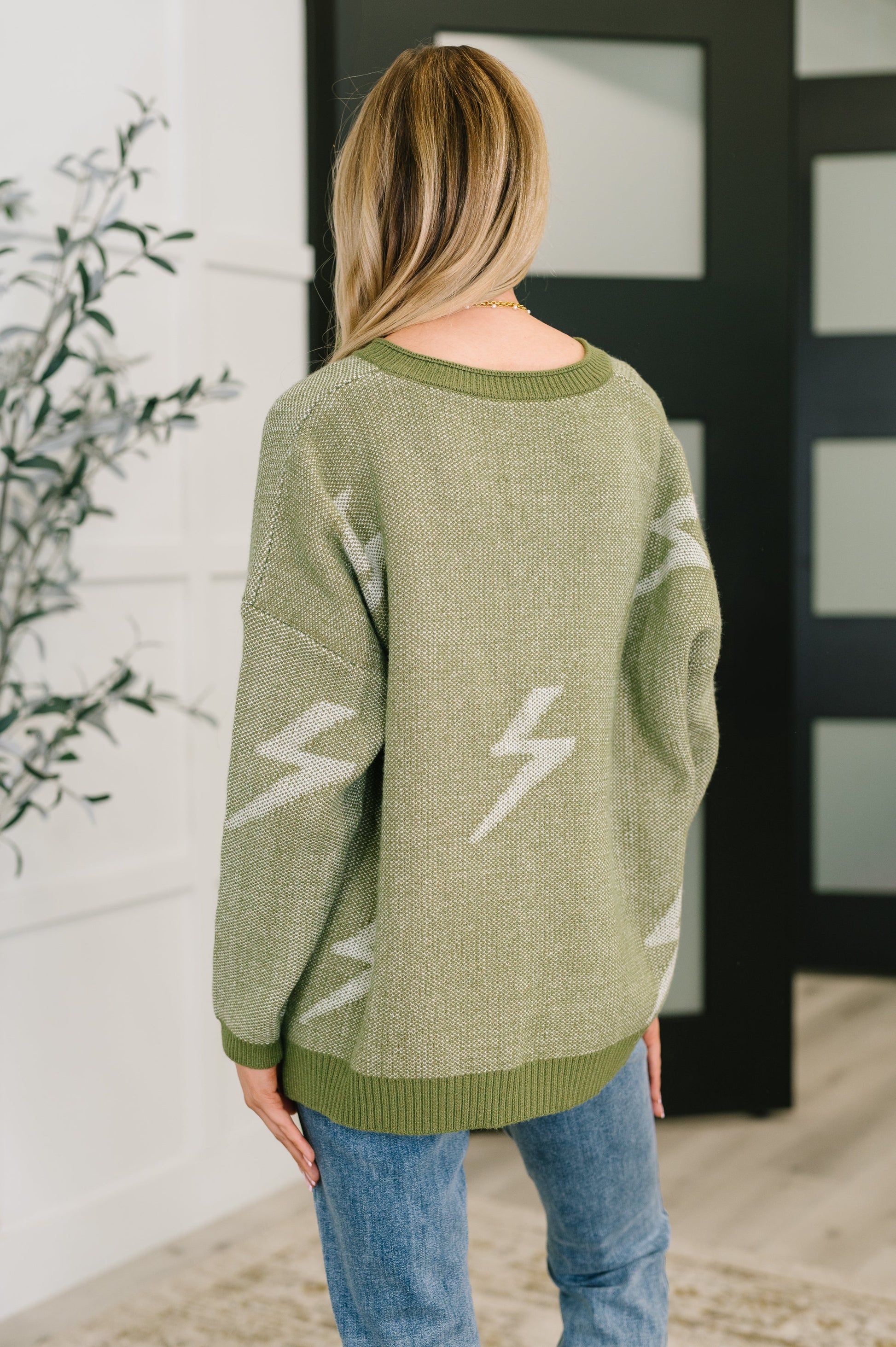 Olive green oversized Shock Value V-Neck Sweater with white lightning bolts