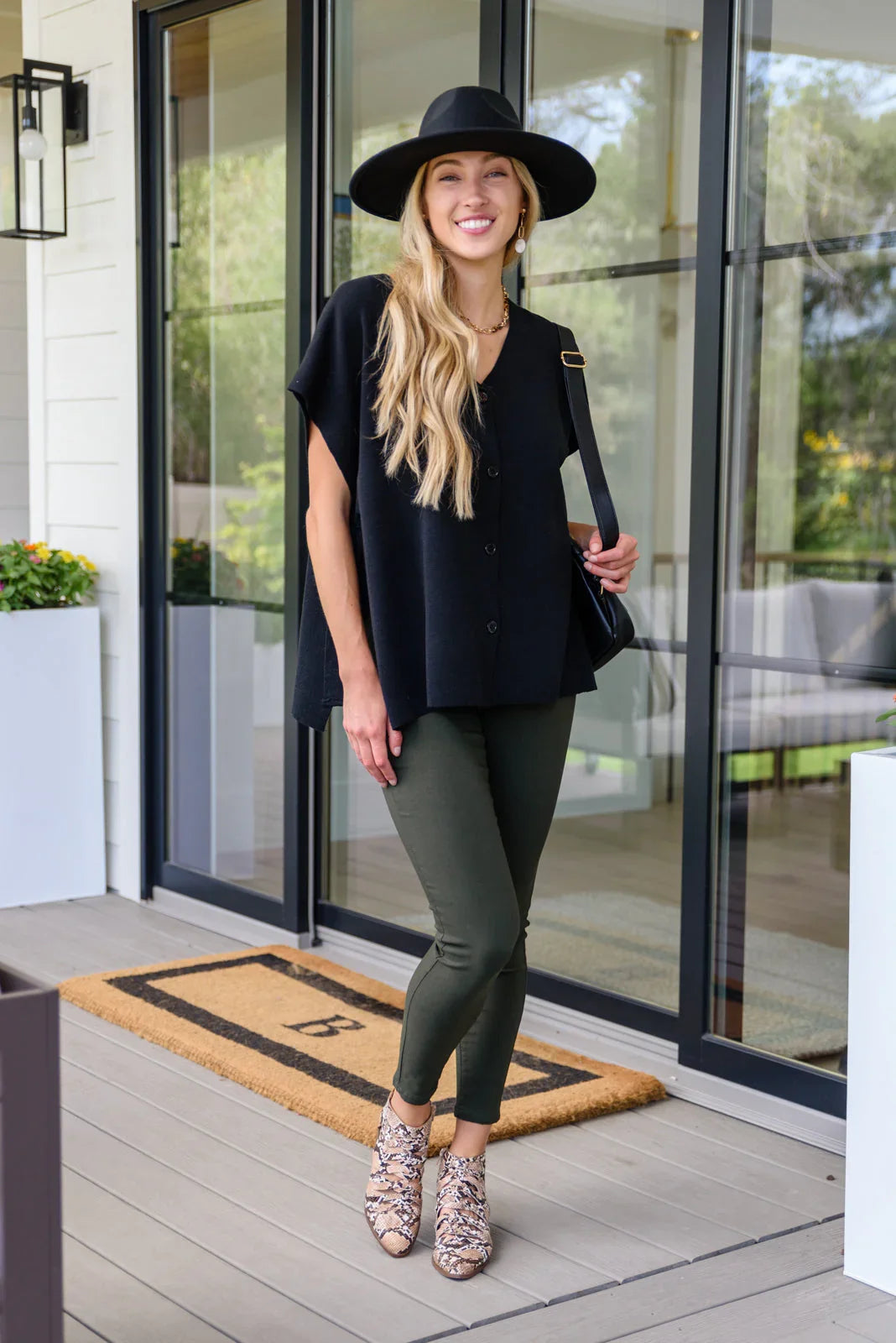 Black wide-brimmed felt hat with subtle sheen on Andree by Unit top