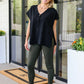 Andree by Unit Finale Black Side Tie Top with olive green leggings and snakeskin ankle boots
