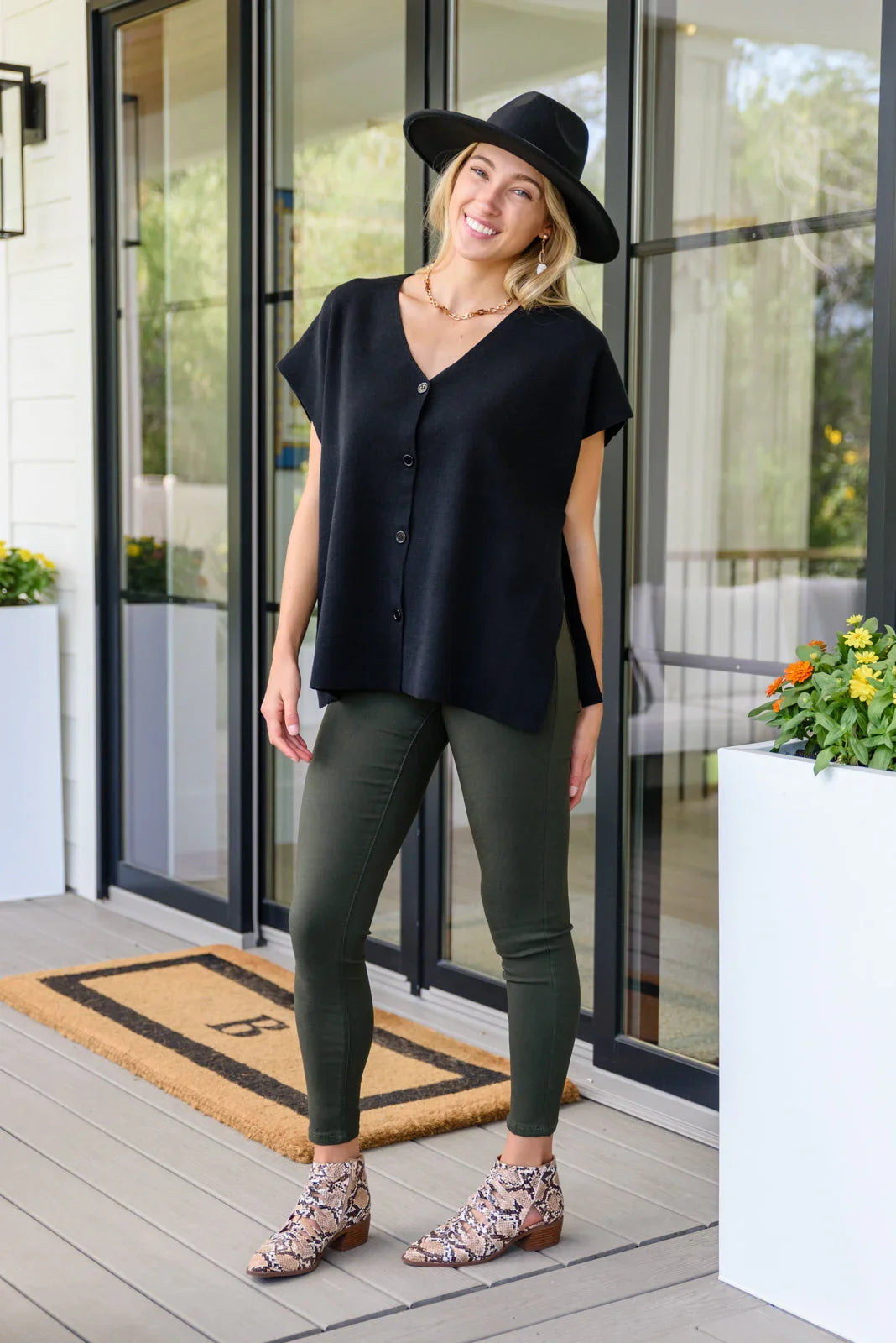 Andree by Unit Finale Black Side Tie Top with olive green leggings and snakeskin ankle boots