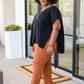 Andree by Unit Finale black side tie top with orange pants and ankle boots