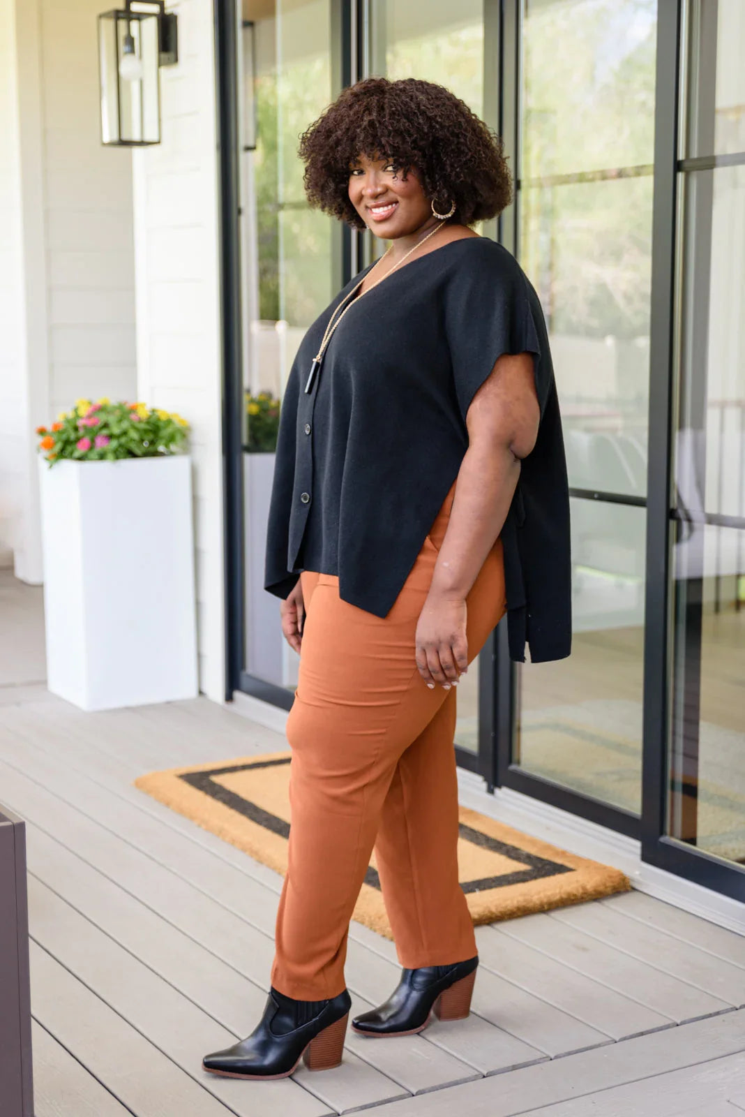 Andree by Unit Finale black side tie top with orange pants and ankle boots