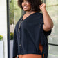 Andree by Unit Finale black tassel blouse with orange skirt and silver necklace