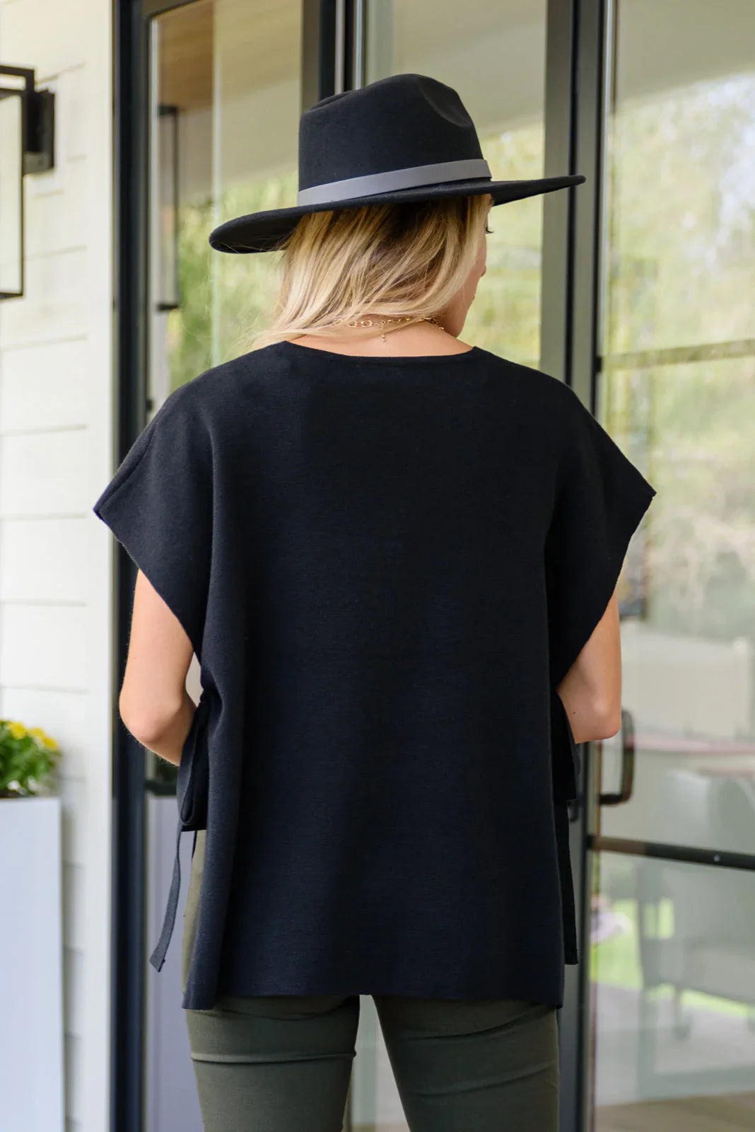 Classic black fedora with wide brim and felt band on Andree top