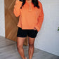 Orange plus size henley top with black shorts and flip flops