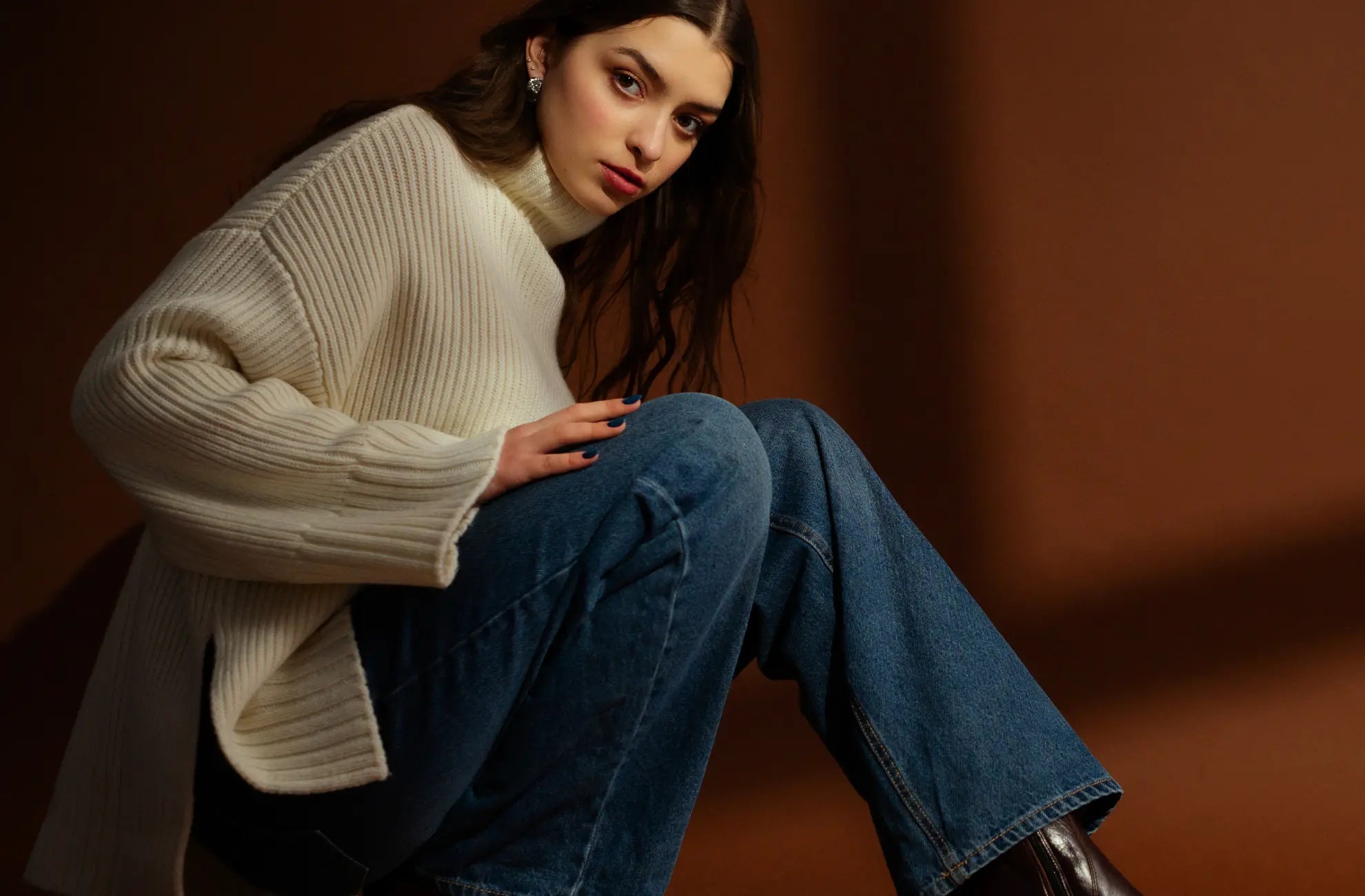 Cream-colored ribbed knit turtleneck sweater.