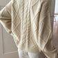 Cream-colored cable-knit crewneck long sleeve loose sweater