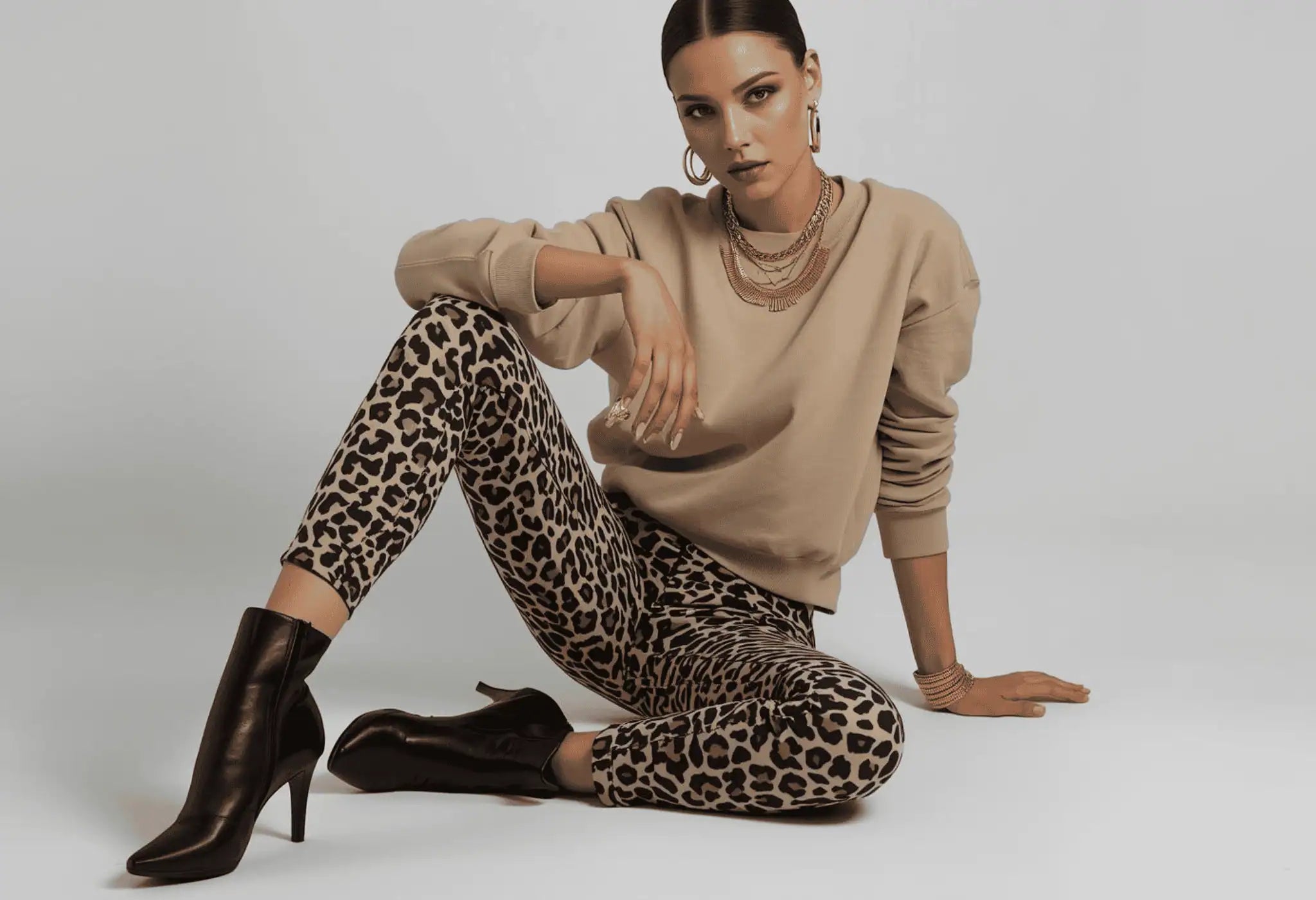 Woman wearing fall outfit with leopard print pants