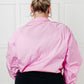 Pink satin bomber jacket with puffed sleeves and cropped hem