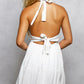 Back view of POL Floral Halter Neck Flowy white mini dress with tied-back and pleats