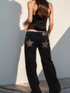 Black denim wide leg jeans with leopard-print star patches on back pockets