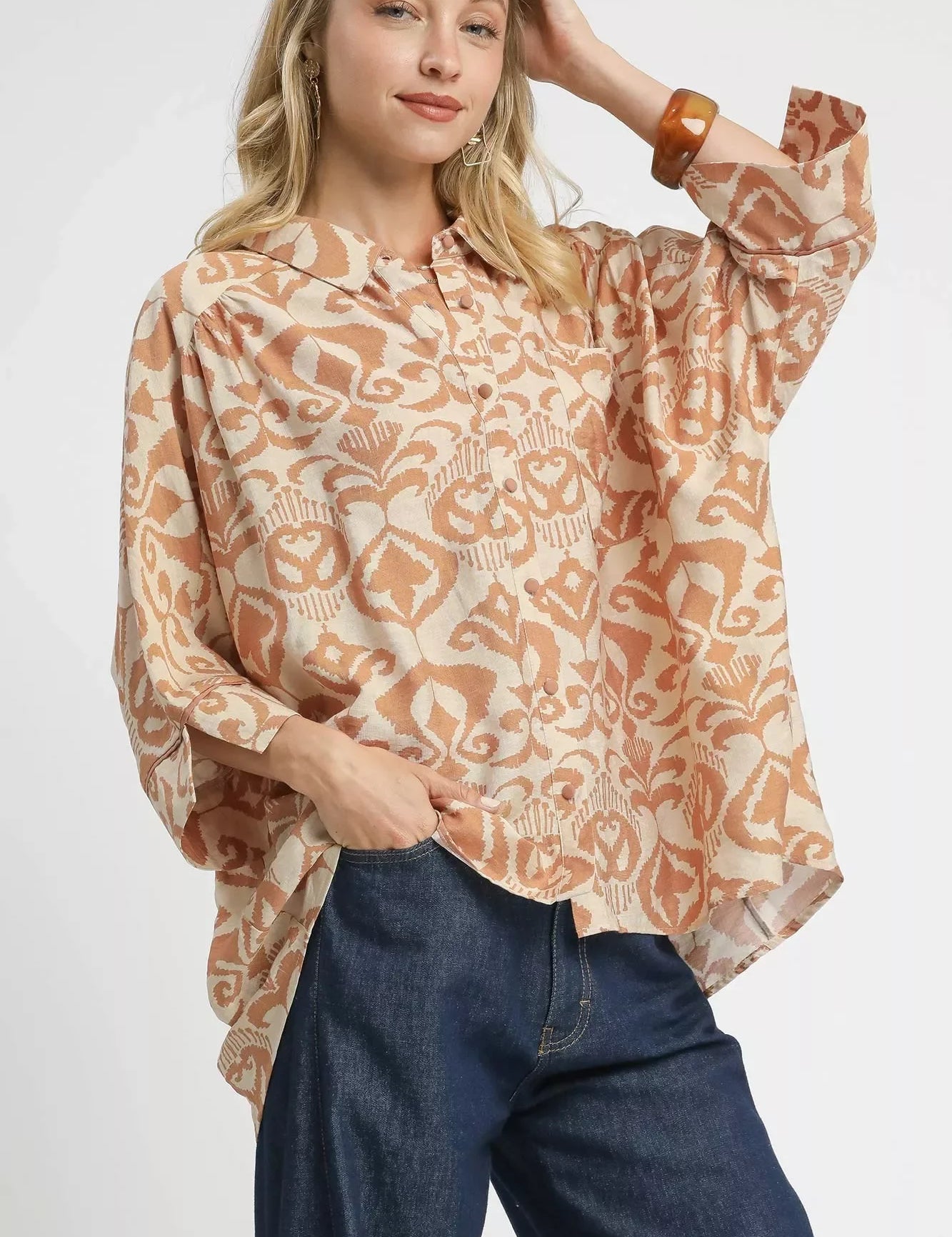 Umgee abstract print button-up oversized shirt in beige, brown, orange paisley with long sleeves and ruffled collar