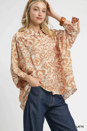 Umgee abstract print button-up oversized shirt in beige, brown, orange paisley with long sleeves and ruffled collar