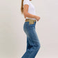Judy Blue mid-rise jeans with blue denim flare legs and tan belt