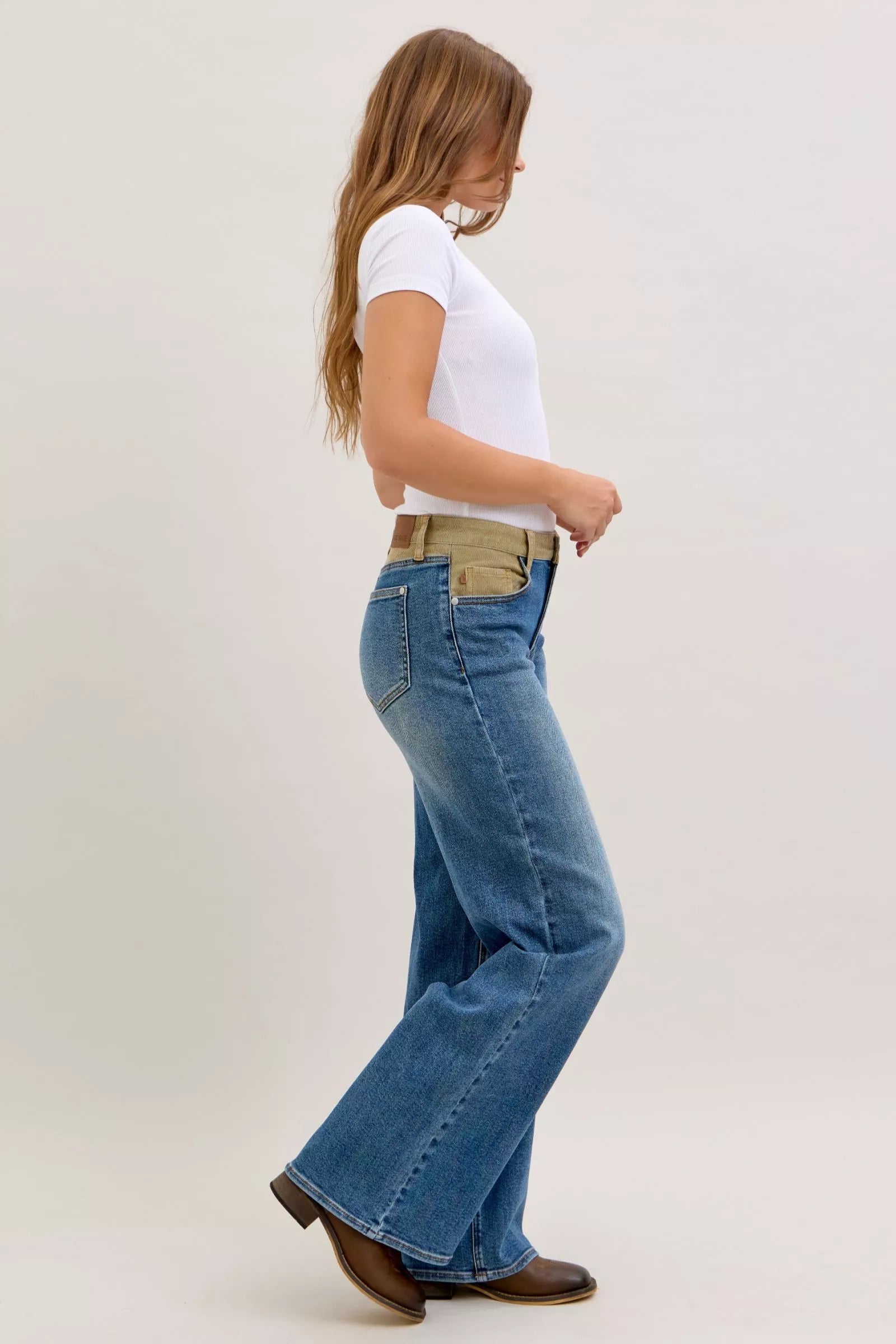 Judy Blue mid-rise jeans with blue denim flare legs and tan belt