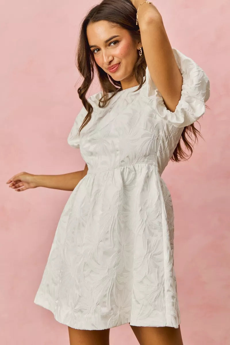 White textured mini dress with floral jacquard puffed sleeves and flared skirt