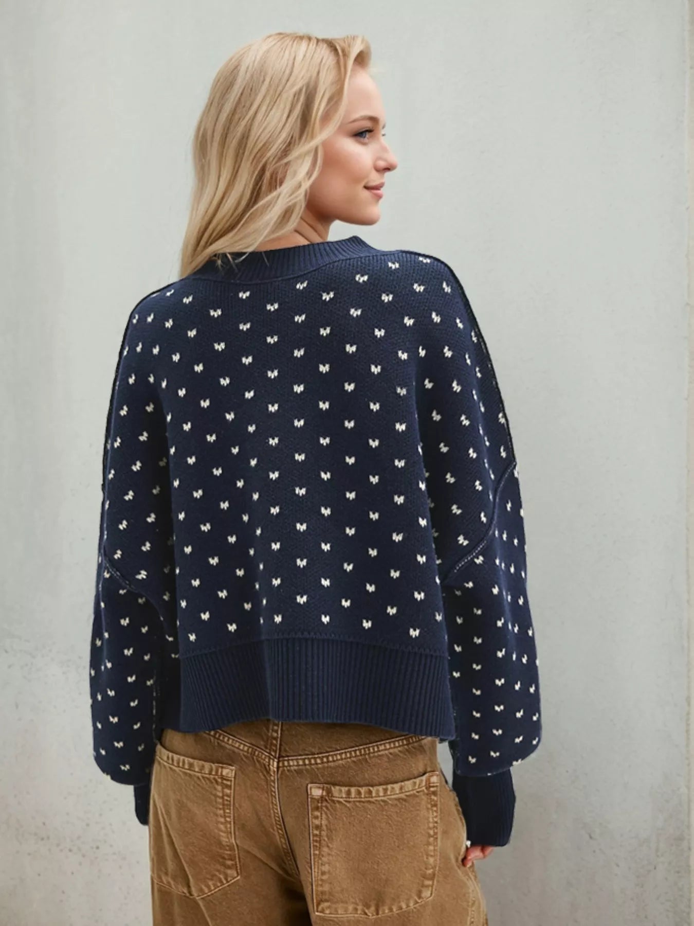 Daverri navy blue knit sweater with white butterfly motifs and ribbed trim