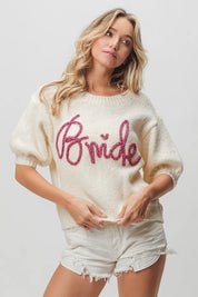 Cream-colored bride sweater with pink sequin lettering and puff sleeves
