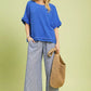 Vibrant cerulean Umgee linen top with ruffled sleeves and frayed hem